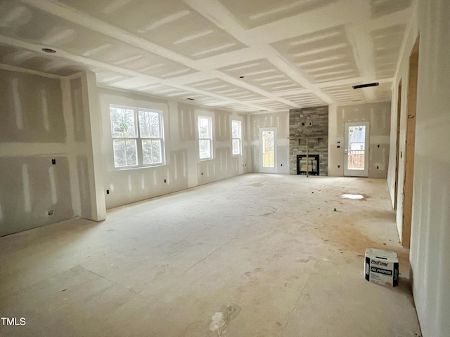 unfurnished living room with a stone fireplace