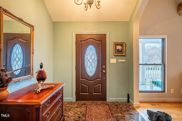 entryway featuring vaulted ceiling and light wood-type flooring