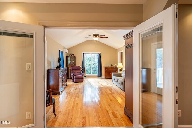 hall with vaulted ceiling and light hardwood / wood-style flooring