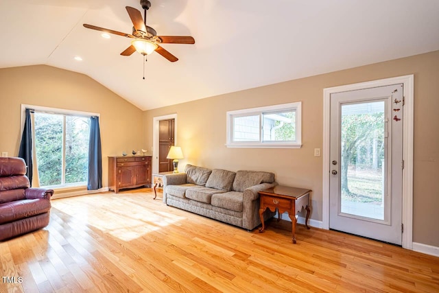 living room with lofted ceiling, ceiling fan, light hardwood / wood-style floors, and a healthy amount of sunlight