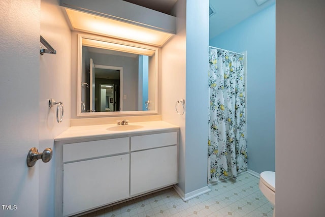 bathroom with walk in shower, vanity, and toilet