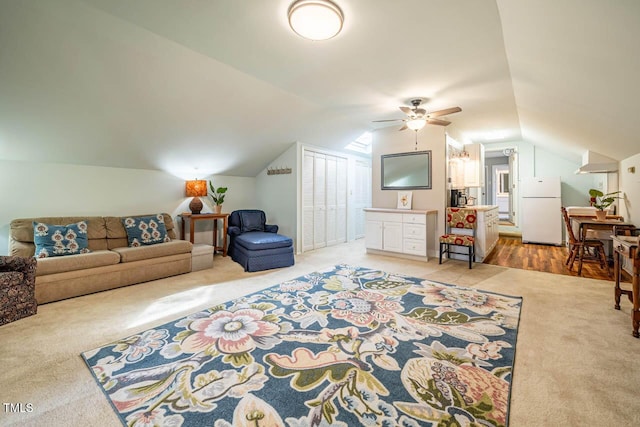 carpeted living room featuring vaulted ceiling and ceiling fan