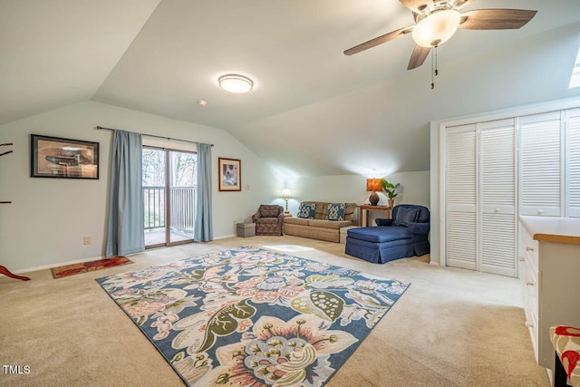 interior space featuring light carpet, vaulted ceiling, and ceiling fan