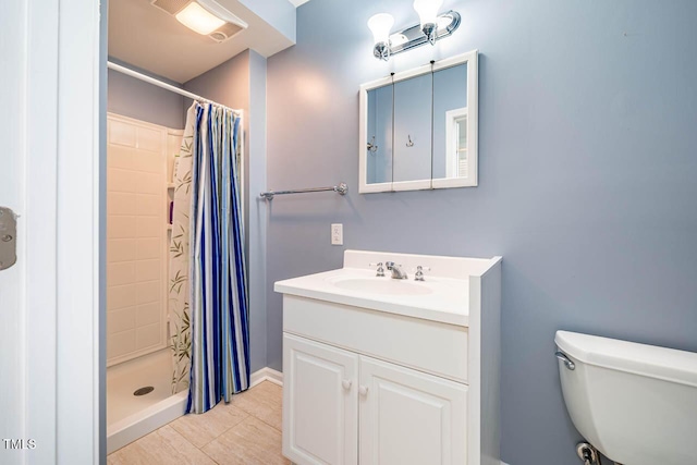 bathroom with a shower with shower curtain, vanity, tile patterned flooring, and toilet