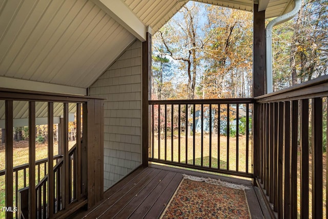 wooden terrace featuring a lawn