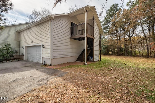 view of side of property with a balcony and a garage