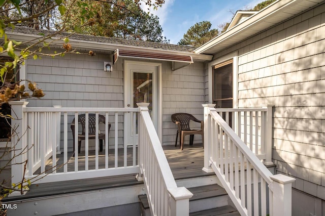 view of exterior entry with a wooden deck