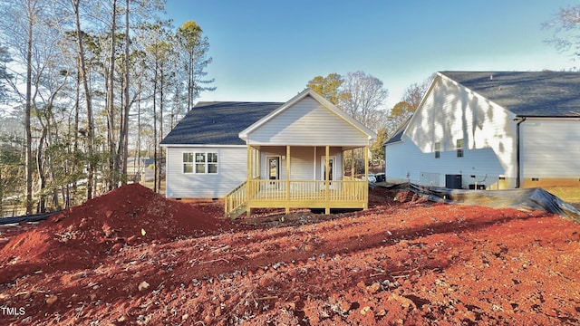 rear view of property with a porch and central AC unit