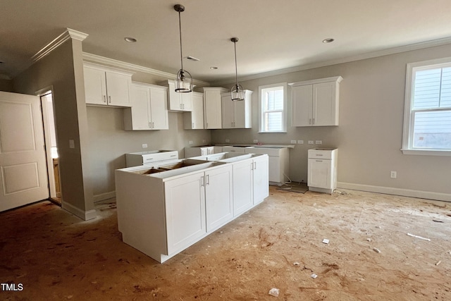 kitchen featuring a healthy amount of sunlight, a kitchen island, and white cabinets