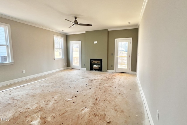 unfurnished living room with ornamental molding, plenty of natural light, and ceiling fan