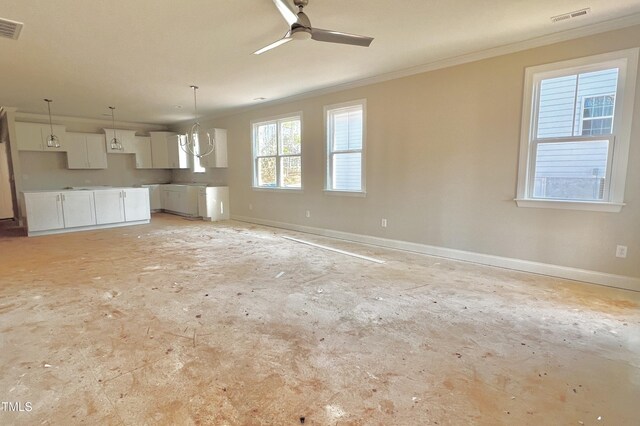 unfurnished living room with ceiling fan and ornamental molding