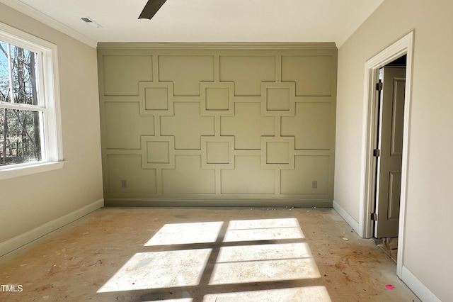 spare room with ornamental molding and plenty of natural light