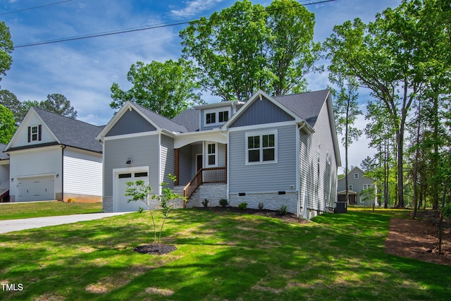 craftsman-style house with a garage, driveway, and a front lawn