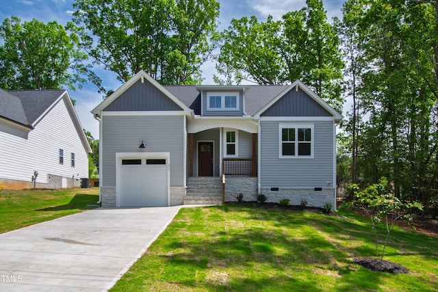 craftsman house featuring a garage, covered porch, a front yard, central AC unit, and concrete driveway