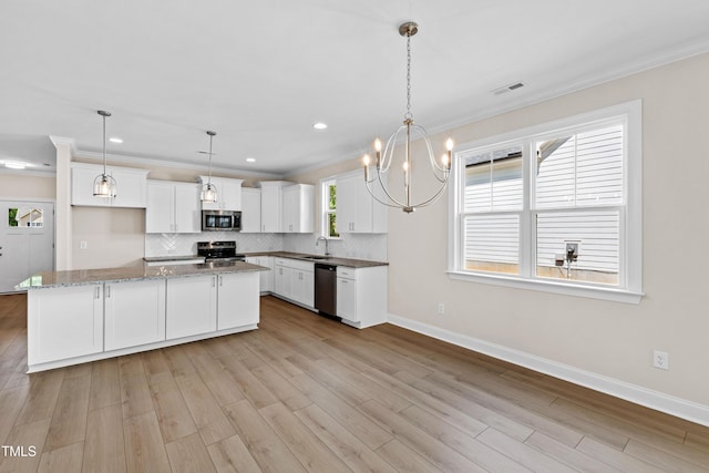kitchen featuring backsplash, appliances with stainless steel finishes, baseboards, ornamental molding, and white cabinetry