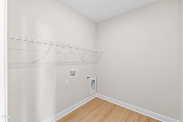 clothes washing area with washer hookup, laundry area, electric dryer hookup, baseboards, and light wood-style flooring