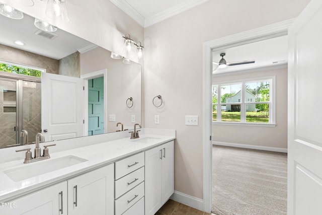 bathroom featuring a sink, ornamental molding, and visible vents