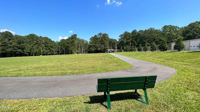 view of community with fence and a yard