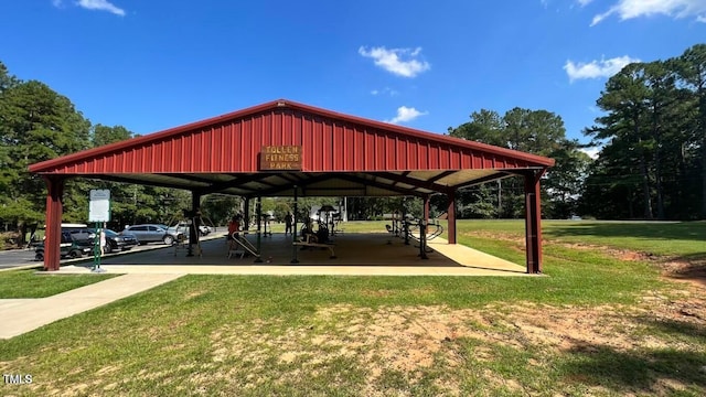 view of property's community featuring a lawn, a carport, and a gazebo