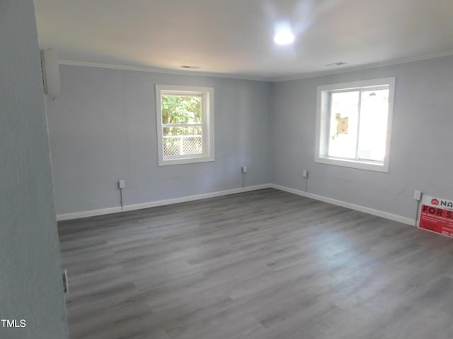 unfurnished room featuring wood-type flooring and ornamental molding