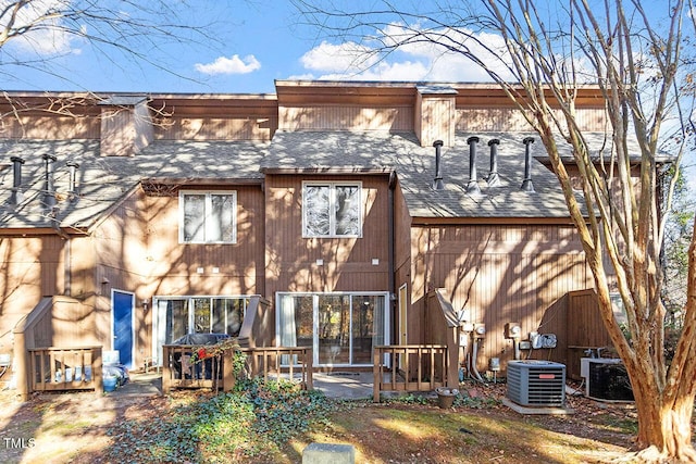 rear view of property with central AC unit