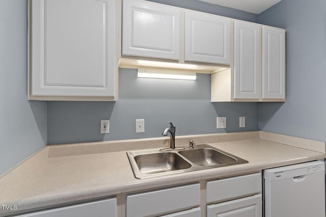 kitchen with dishwasher, white cabinets, and sink