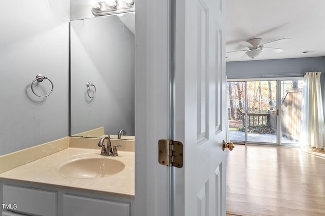 bathroom with wood-type flooring, vanity, and ceiling fan