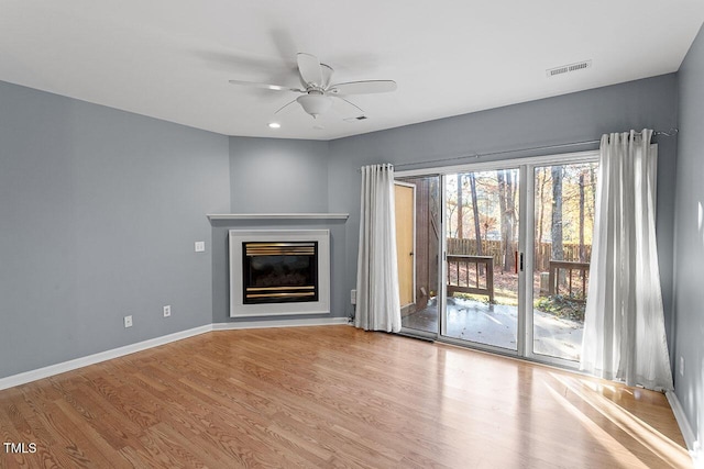 unfurnished living room with ceiling fan and light hardwood / wood-style floors