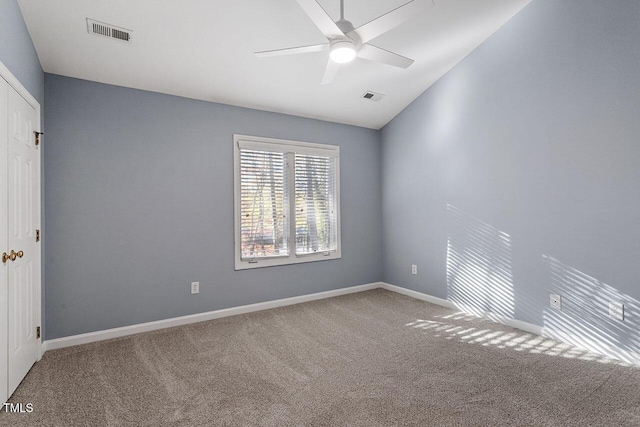 carpeted empty room with ceiling fan and lofted ceiling