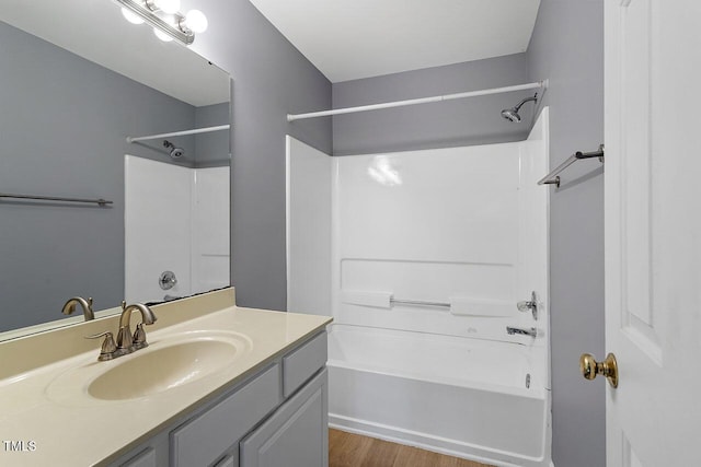 bathroom with vanity, shower / bath combination, and hardwood / wood-style flooring