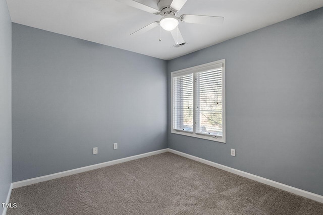 carpeted spare room with ceiling fan