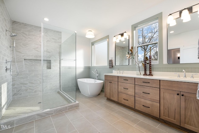 bathroom with shower with separate bathtub, vanity, and tile patterned floors