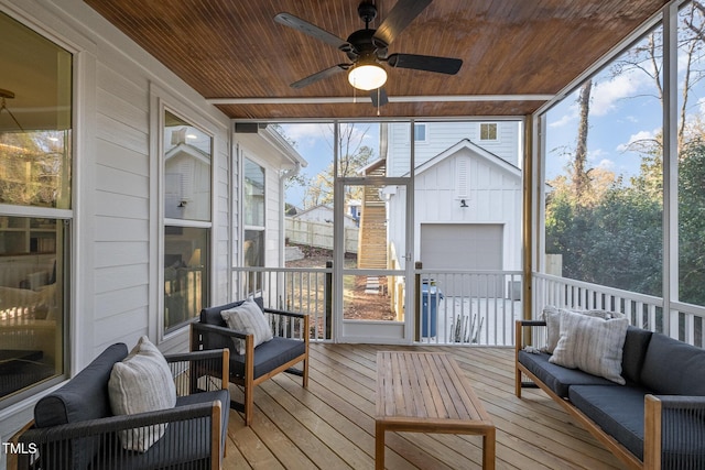 sunroom / solarium featuring a wealth of natural light, wooden ceiling, and ceiling fan