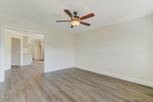 unfurnished room featuring hardwood / wood-style floors and ceiling fan