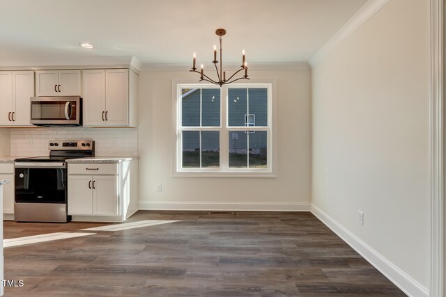 kitchen featuring stainless steel appliances, white cabinetry, hanging light fixtures, and dark wood-type flooring