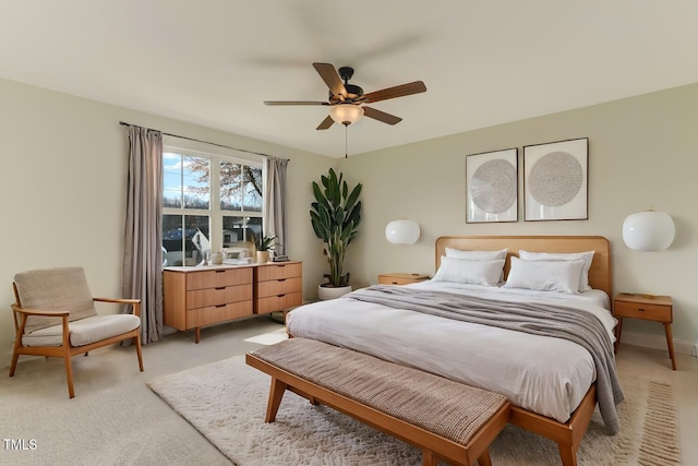 bedroom with ceiling fan and light carpet