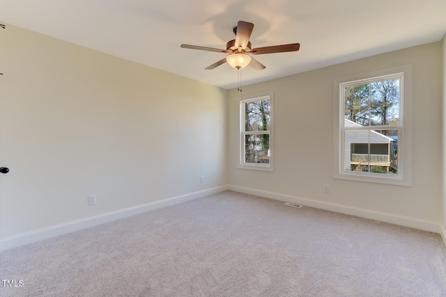 spare room featuring ceiling fan and light colored carpet