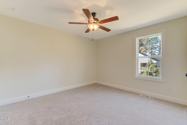 carpeted empty room featuring ceiling fan