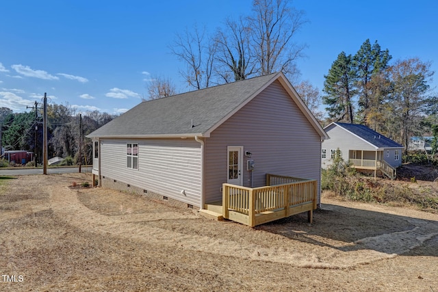 view of side of property featuring a wooden deck