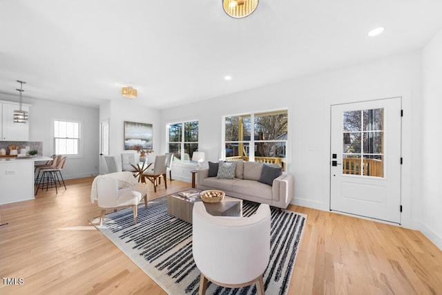 living room with light wood-type flooring and plenty of natural light