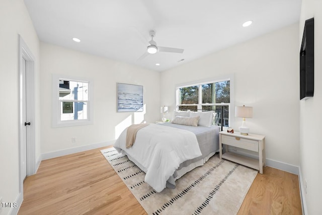 bedroom with ceiling fan and light hardwood / wood-style flooring