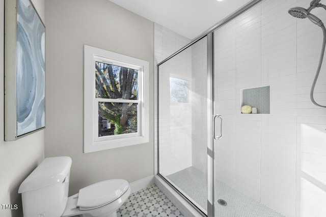 bathroom featuring an enclosed shower and toilet