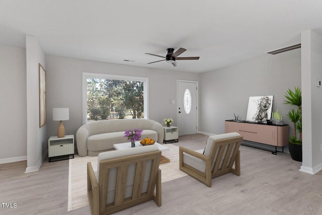 living room with light hardwood / wood-style flooring and ceiling fan