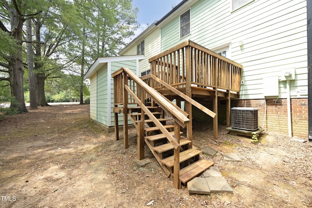 rear view of house with a deck and cooling unit