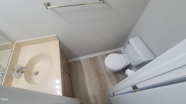 bathroom featuring hardwood / wood-style flooring, vanity, and toilet