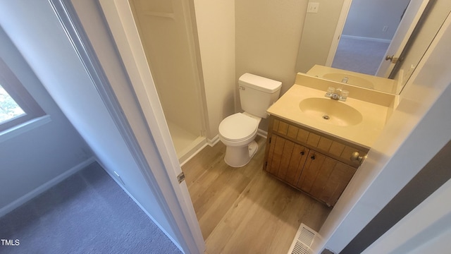 bathroom featuring hardwood / wood-style floors, vanity, and toilet