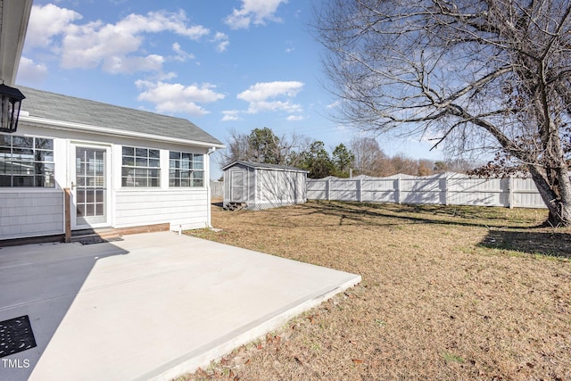 view of yard with a storage shed and a patio area