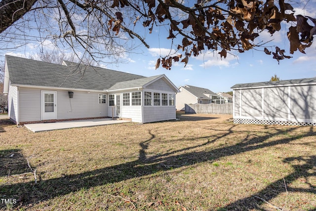 rear view of property featuring a yard and a patio