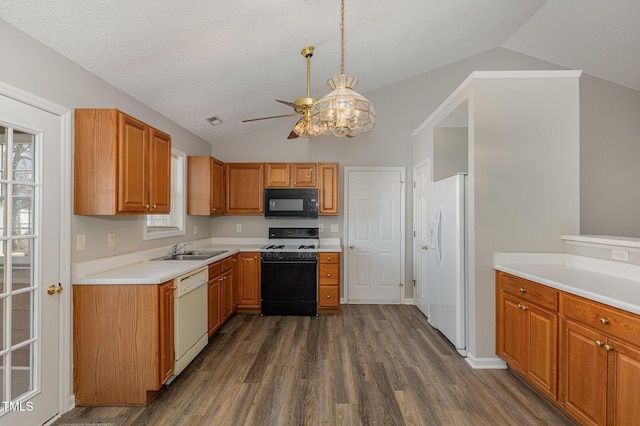 kitchen featuring black appliances, dark hardwood / wood-style flooring, sink, and vaulted ceiling