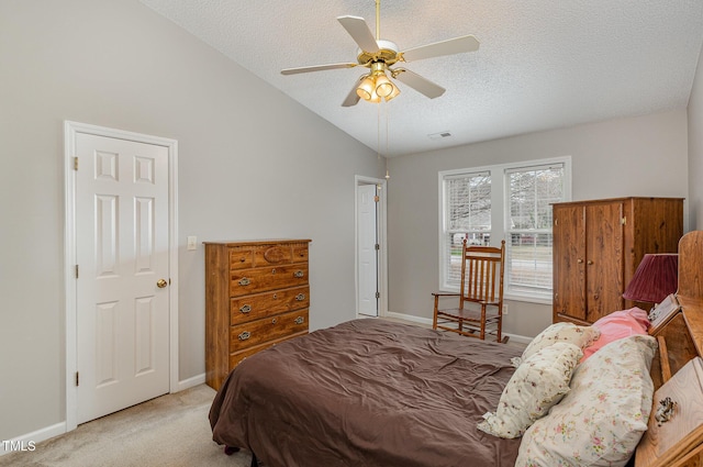 carpeted bedroom featuring a textured ceiling, vaulted ceiling, and ceiling fan